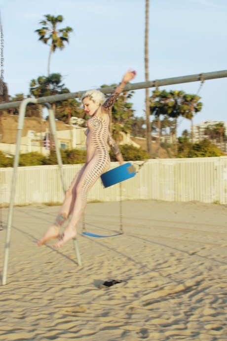 Tattooed blonde Voltaire removes bra and panties before swinging in the nude 17307061